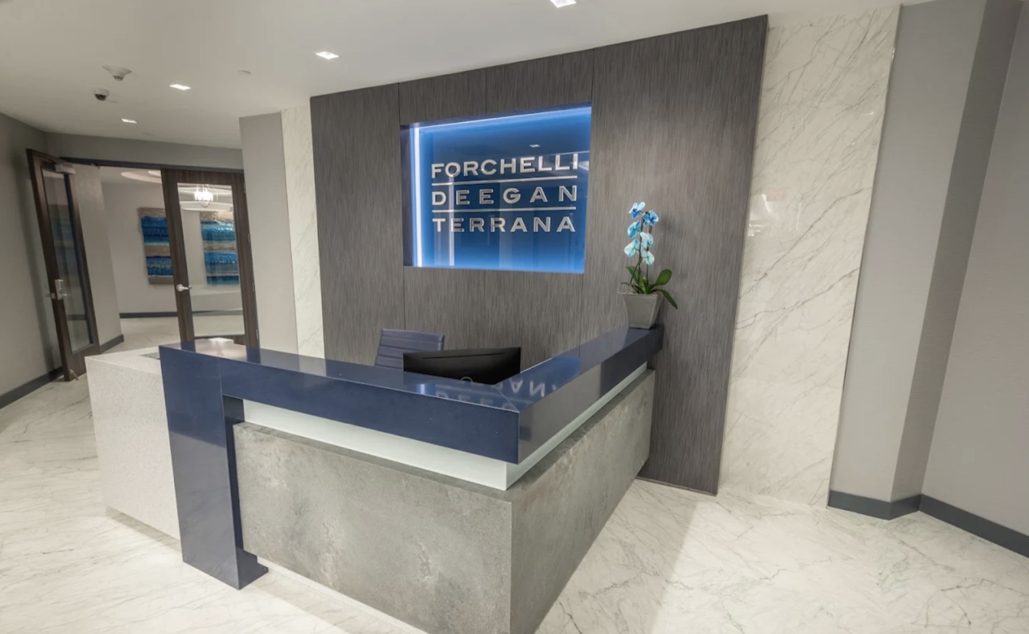 The Forchelli Deegan Terrana nameplate at the Uniondale reception desk.