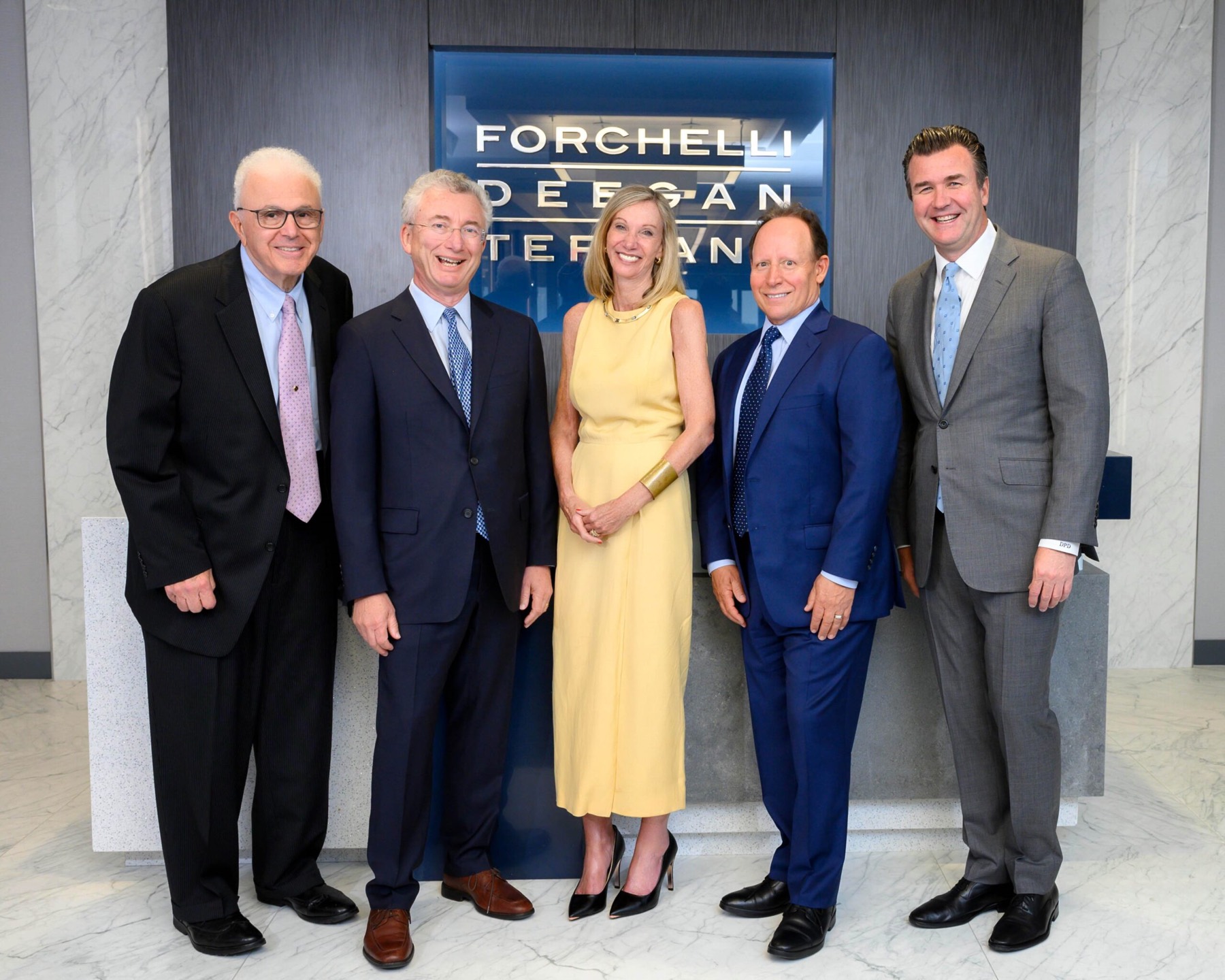 Firm leadership at the Uniondale reception wall.